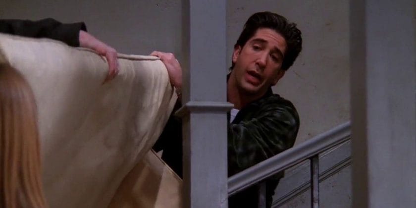 Ross moves the couch upstairs and says "Turn" to "Friends"