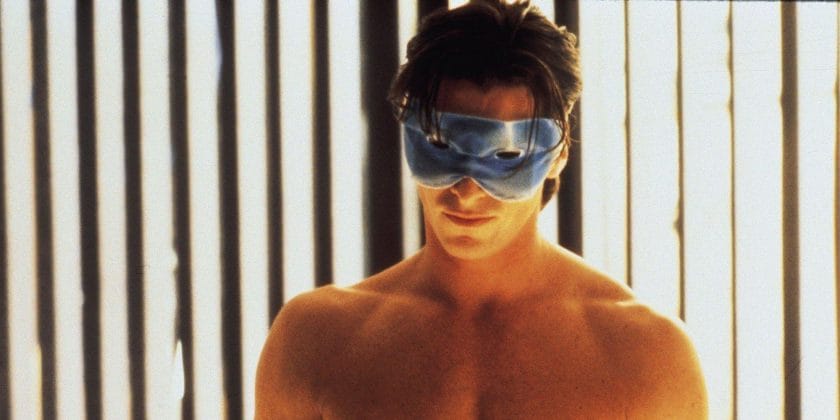 Christian Bale's Patrick Bateman with tanning goggles on in the tanning booth, half naked in American Psycho