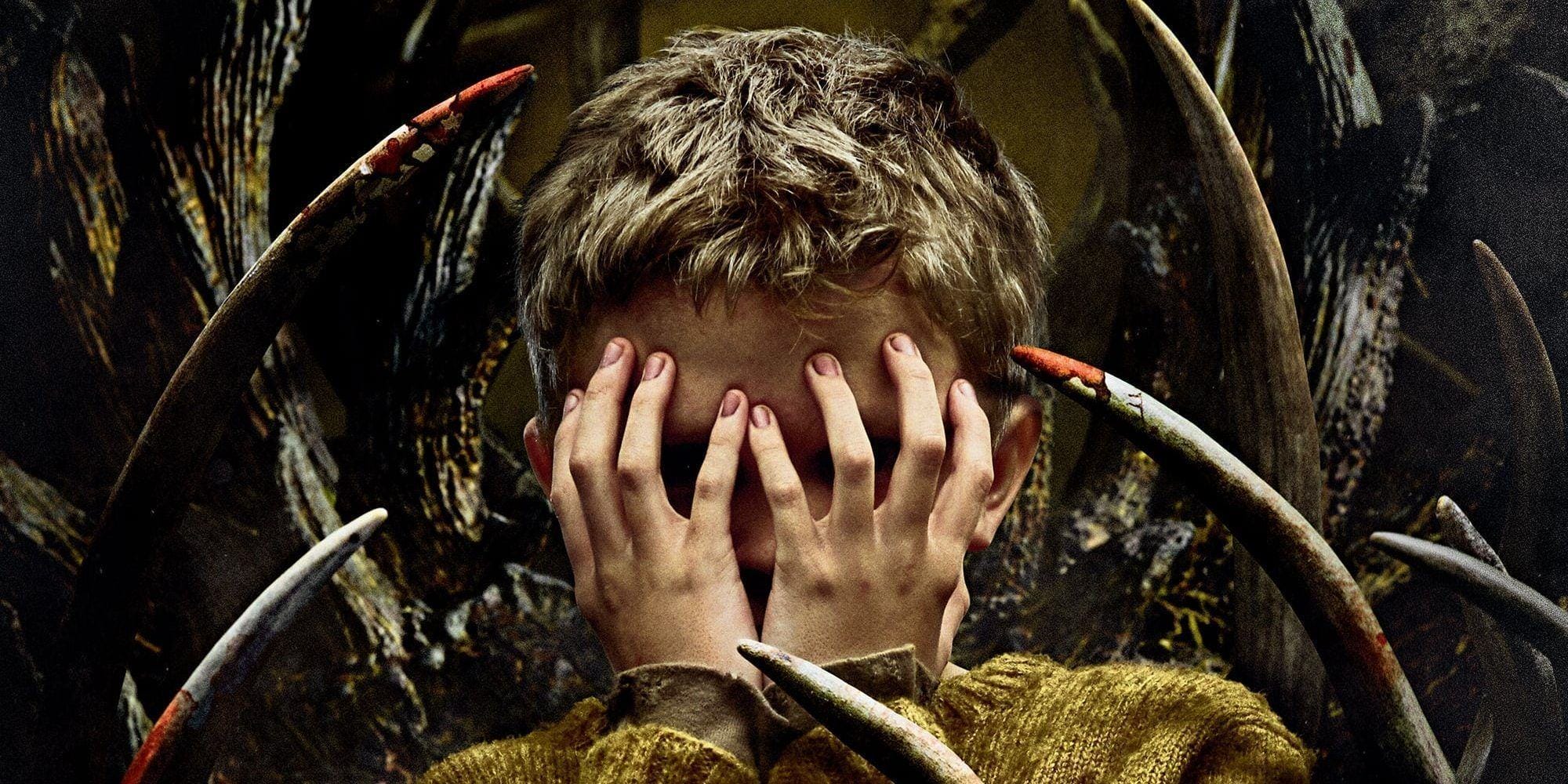 A young boy covering his face in the poster for Antlers