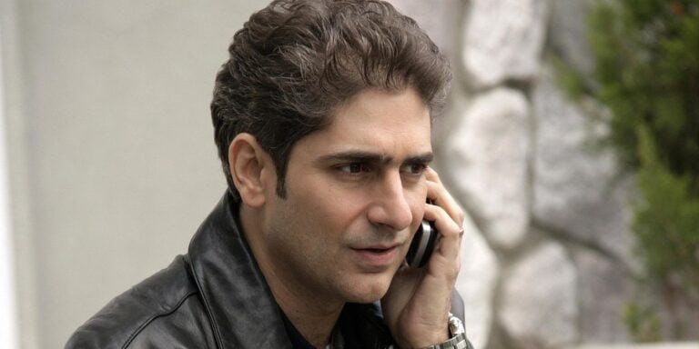 Michael Imperioli as Christopher in The Sopranos wearing a leather jacket and talking on a cell phone