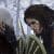 Gameplay screenshot from God of War Ragnarok, where Kratos and Freya stare at each other menacingly.