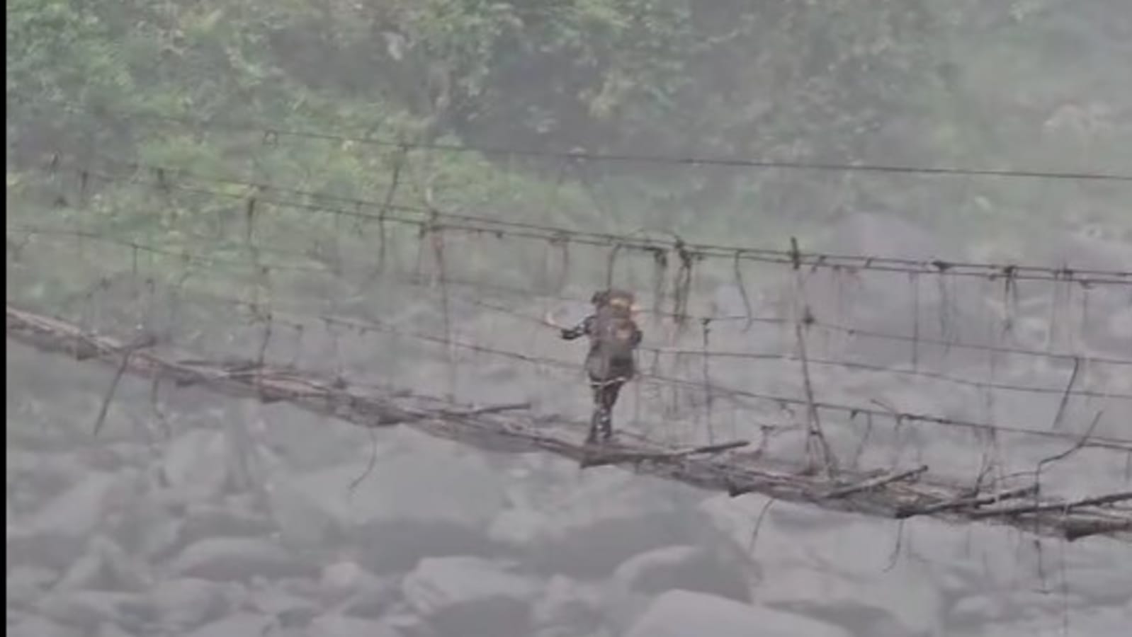 Police personnel cross dangerous, half-broken bamboo bridge after repolling in Arunachal Pradesh. Watch